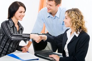 Photo of business women shaking hands at meeting